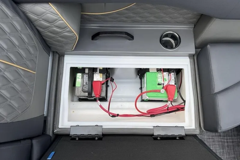 Slide: The Image of Battery compartment of 2026 Godfrey Sanpan 2700 ULW Twin with red cables and cup holder. - 38