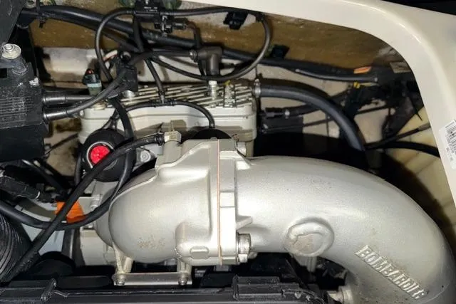 Slide: The Image of Engine compartment of a 2001 Sea-Doo GTX, showcasing intricate mechanical components and wiring. - 12