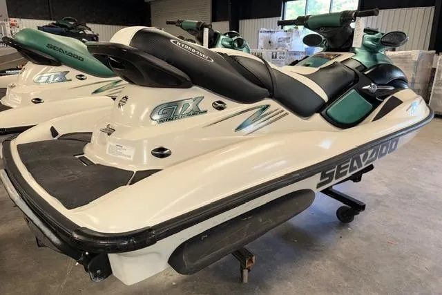 Slide: The Image of 2001 Sea-Doo GTX jet ski in a showroom, showcasing sleek design and branding. - 7