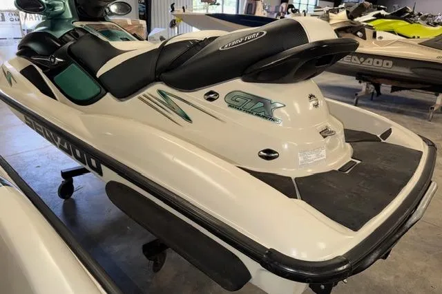 Slide: The Image of 2001 Sea-Doo GTX personal watercraft in showroom, featuring sleek design and comfortable seating. - 9