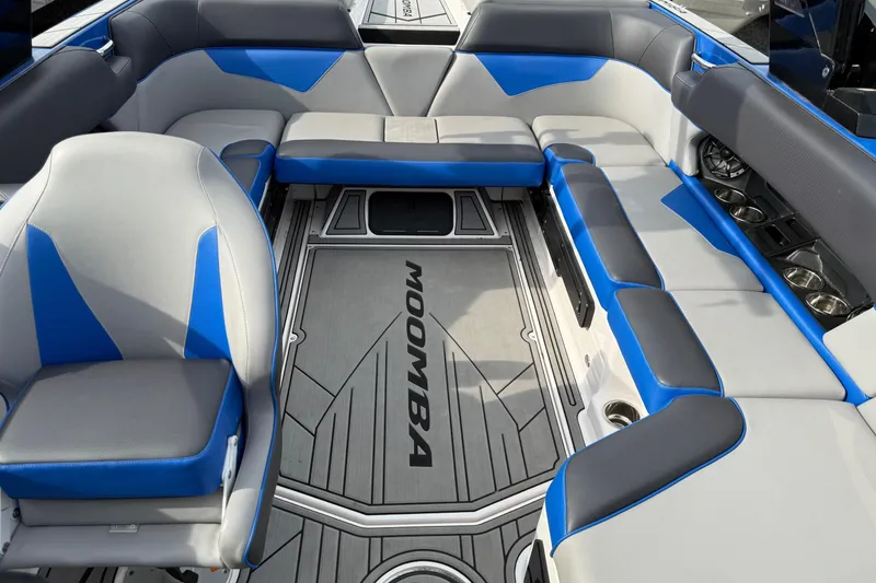 Slide: The Image of 2021 Moomba Kaiyen boat interior with blue and gray seating, spacious layout. - 3