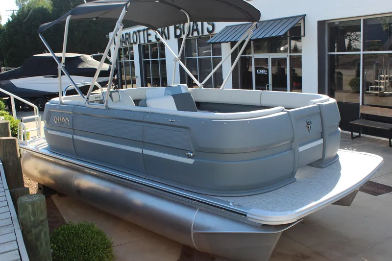Slide: The Image of 2026 Tahoe Pontoon Aura boat with canopy, docked near showroom. - 11