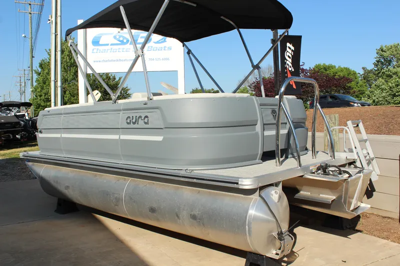 Slide: The Image of 2026 Tahoe Pontoon Aura boat displayed outdoors at dealership. - 15