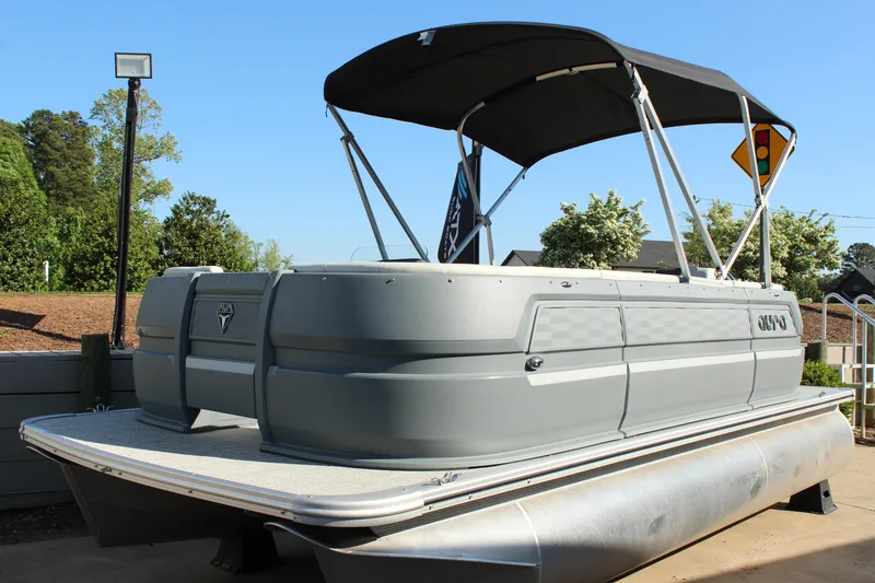 Slide: The Image of 2026 Tahoe Pontoon Aura boat with canopy, docked outdoors on a sunny day. - 17