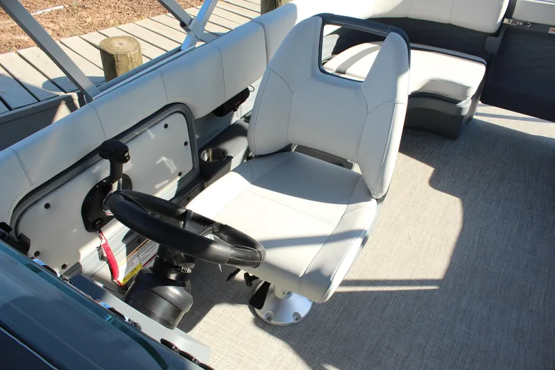 Slide: The Image of 2026 Tahoe Pontoon Aura boat interior with steering wheel and comfortable seating. - 3