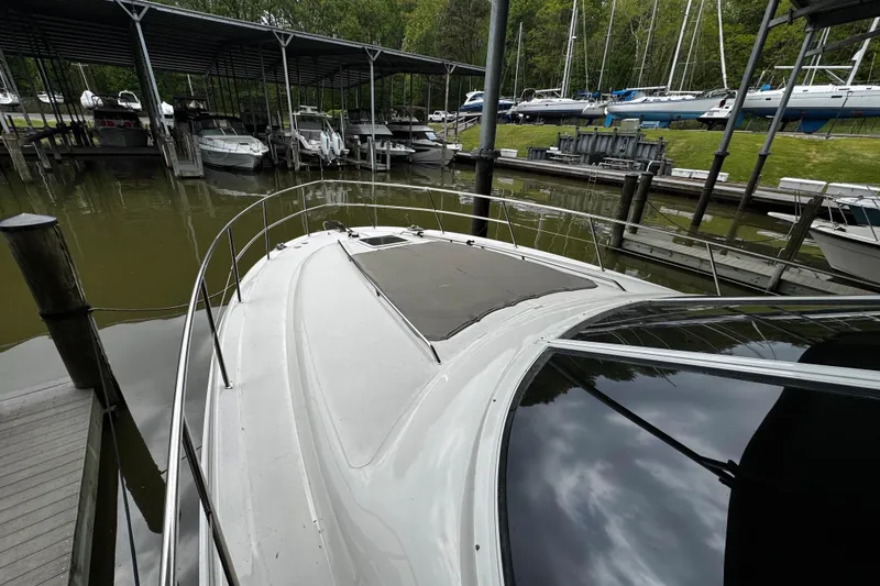 Slide: The Image of 1999 Sea Ray 480 Sedan Bridge yacht docked at marina, surrounded by other boats. - 12