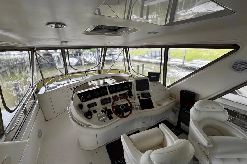 Slide: The Image of Interior helm of 1999 Sea Ray 480 Sedan Bridge yacht with modern controls and seating. - 15