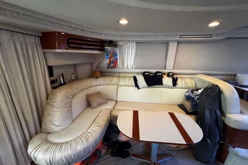 Slide: The Image of Luxurious interior of 1999 Sea Ray 480 Sedan Bridge yacht with plush seating and table. - 22