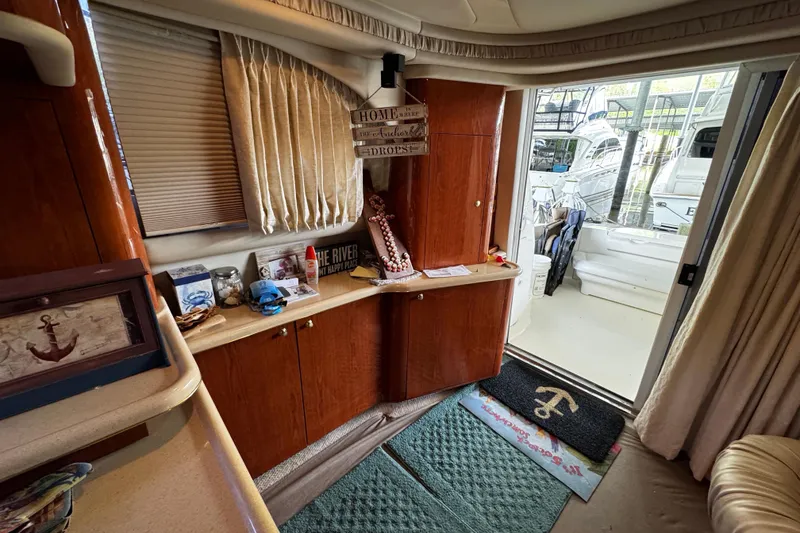 Slide: The Image of Interior of 1999 Sea Ray 480 Sedan Bridge yacht with nautical decor and open door to deck. - 23