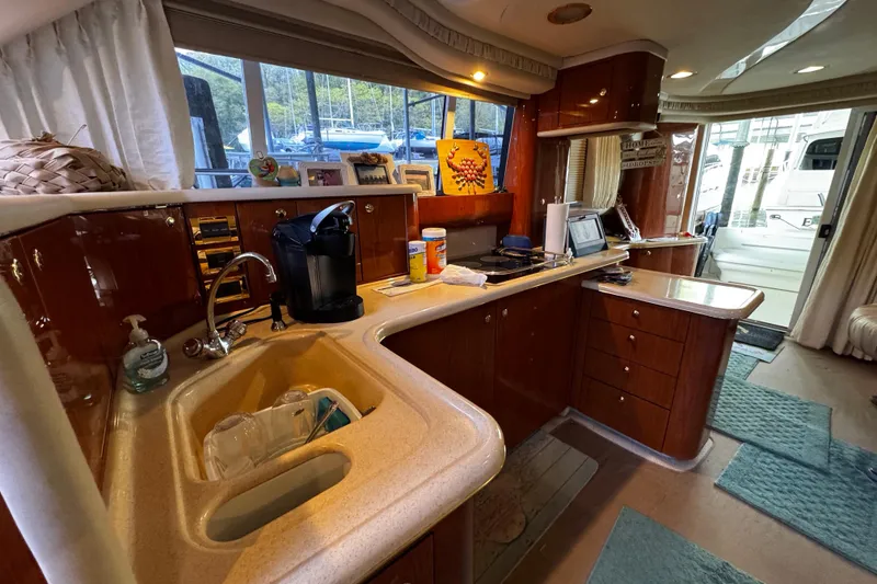 Slide: The Image of Luxurious 1999 Sea Ray 480 Sedan Bridge yacht interior with modern kitchen amenities. - 25