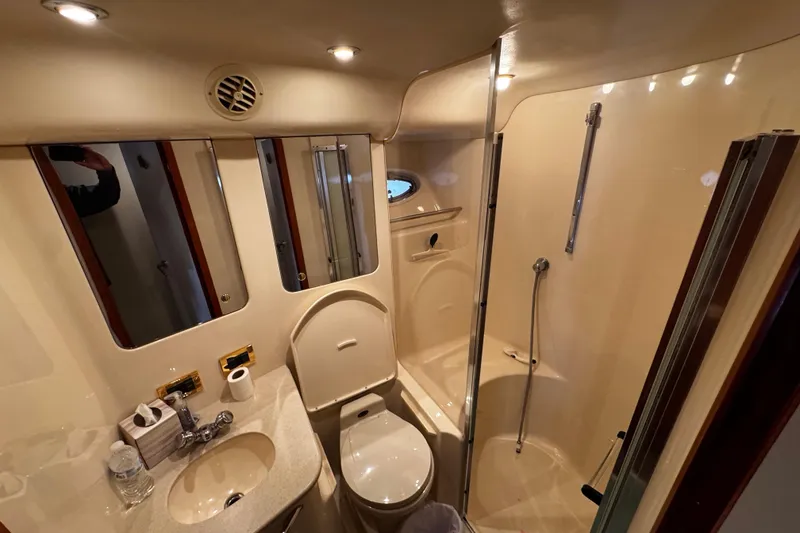 Slide: The Image of Luxurious bathroom in 1999 Sea Ray 480 Sedan Bridge yacht with shower and vanity. - 30