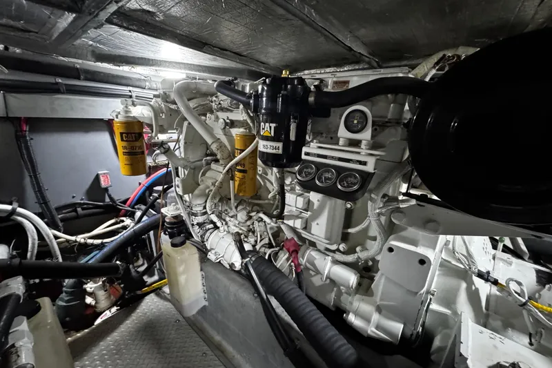 Slide: The Image of Engine room of a 1999 Sea Ray 480 Sedan Bridge with CAT filters and gauges. - 35