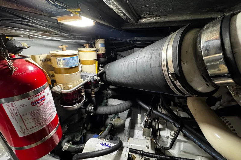 Slide: The Image of Engine room of 1999 Sea Ray 480 Sedan Bridge with fire extinguisher and fuel filters. - 37