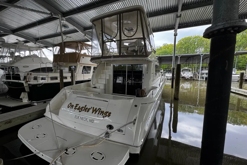 Slide: The Image of 1999 Sea Ray 480 Sedan Bridge yacht docked in marina, rear view. - 5