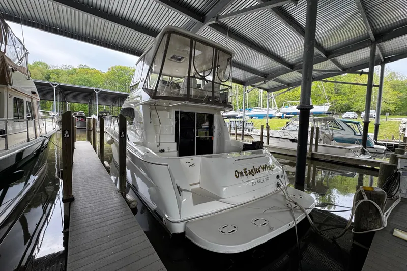 Slide: The Image of 1999 Sea Ray 480 Sedan Bridge yacht docked in a covered marina. - 6