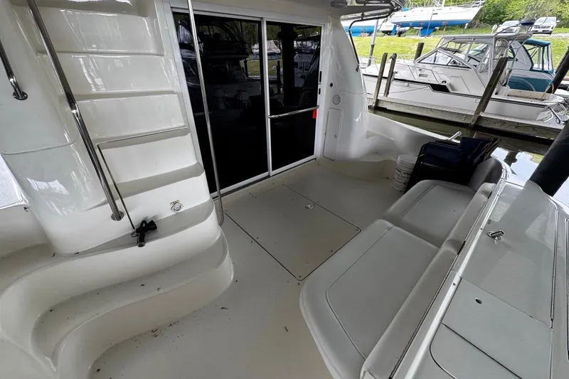 Slide: The Image of 1999 Sea Ray 480 Sedan Bridge yacht interior with seating and stairs. - 9