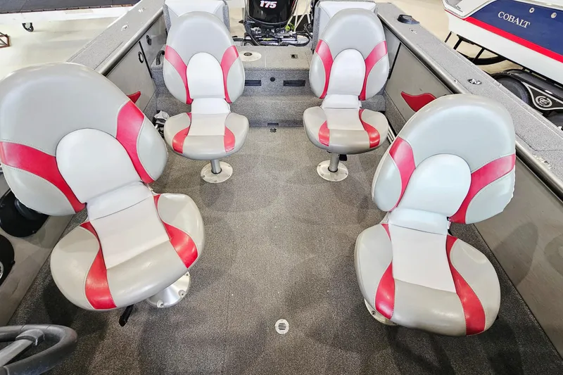 Slide: The Image of Four red and gray seats inside a 2011 Alumacraft Trophy 195 boat. - 10