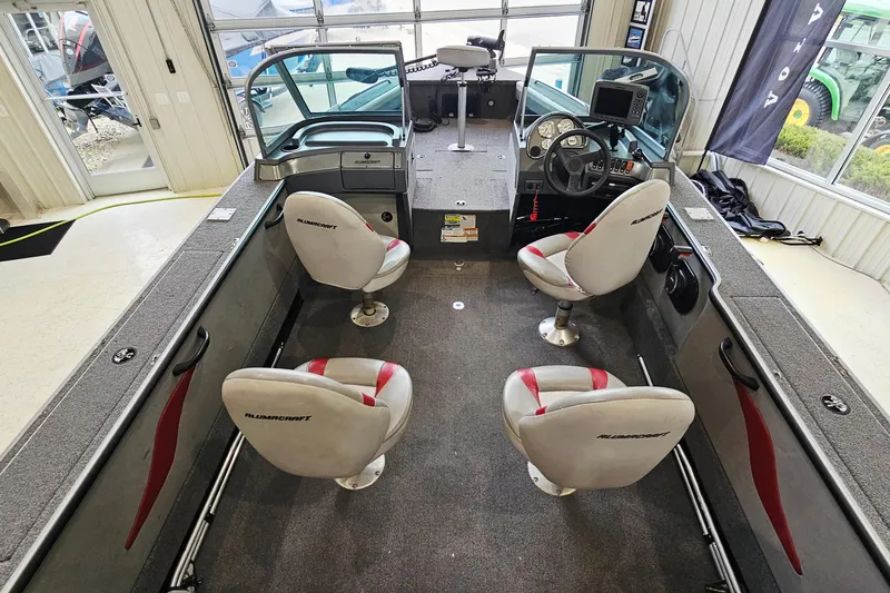 Slide: The Image of 2011 Alumacraft Trophy 195 boat interior with four seats and steering console. - 11