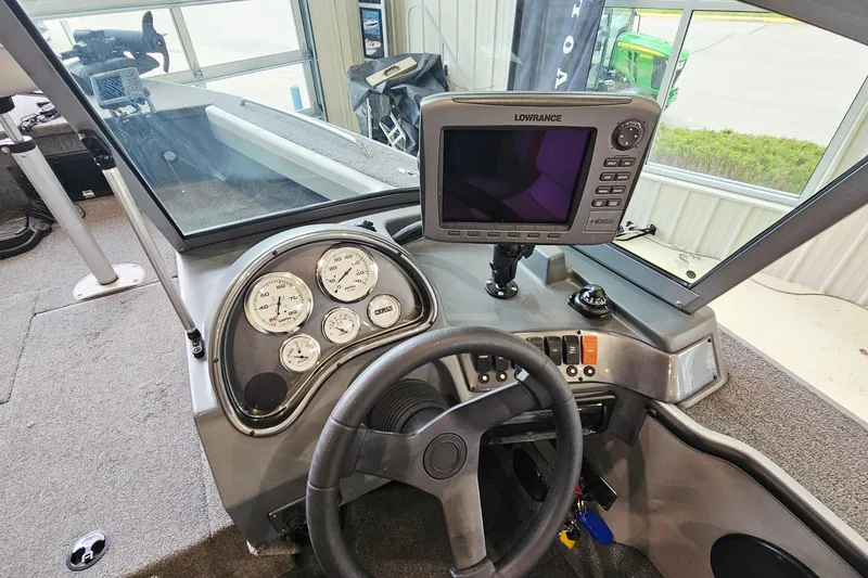 Slide: The Image of 2011 Alumacraft Trophy 195 dashboard with gauges and Lowrance fishfinder. - 12