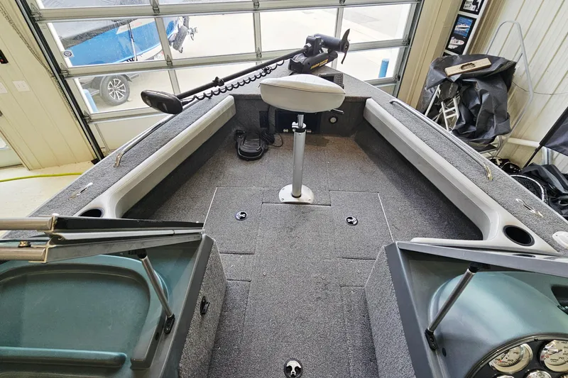 Slide: The Image of 2011 Alumacraft Trophy 195 boat interior with seating and fishing equipment. - 13