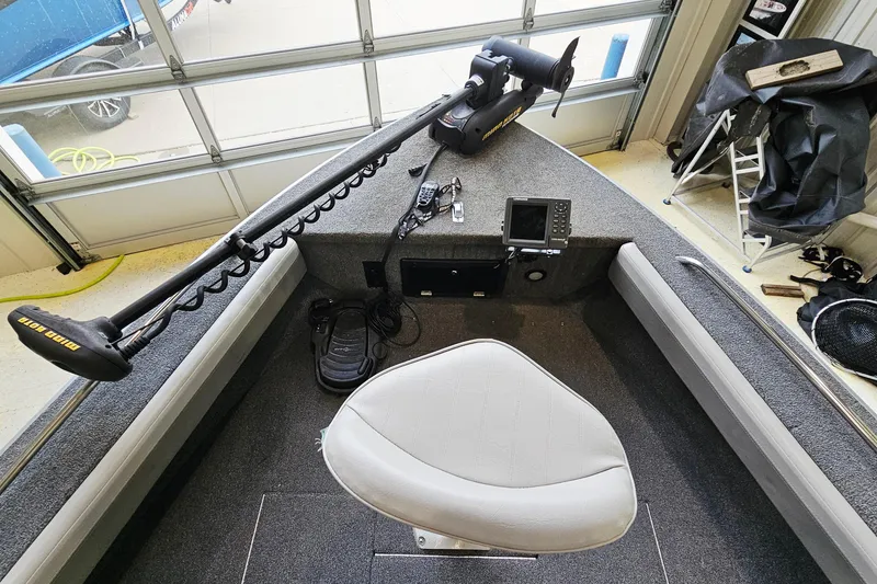 Slide: The Image of 2011 Alumacraft Trophy 195 boat interior with trolling motor and navigation equipment. - 14