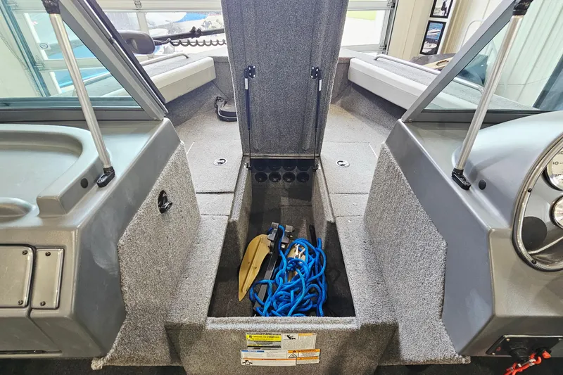 Slide: The Image of Interior of 2011 Alumacraft Trophy 195 boat showing storage compartment with blue rope. - 18