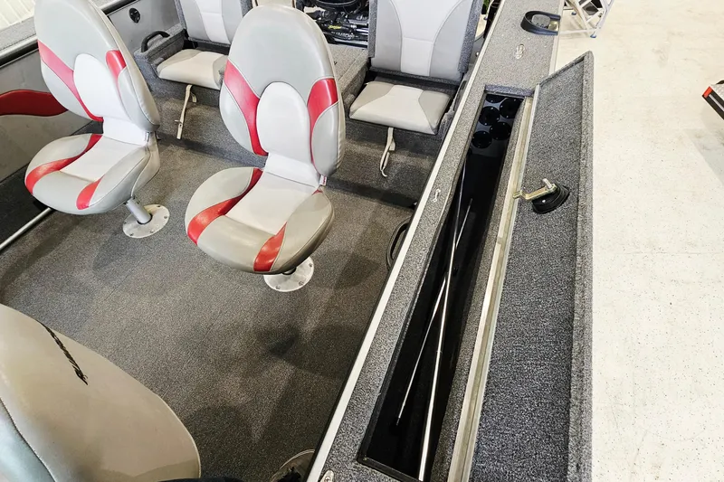 Slide: The Image of 2011 Alumacraft Trophy 195 boat interior with red and gray seating and storage compartment. - 20