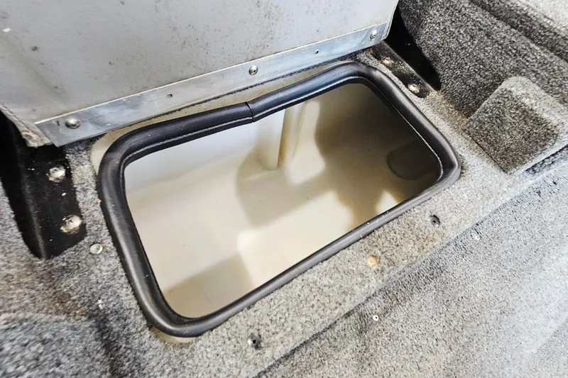 Slide: The Image of Storage compartment in 2011 Alumacraft Trophy 195 boat, featuring carpeted interior. - 22