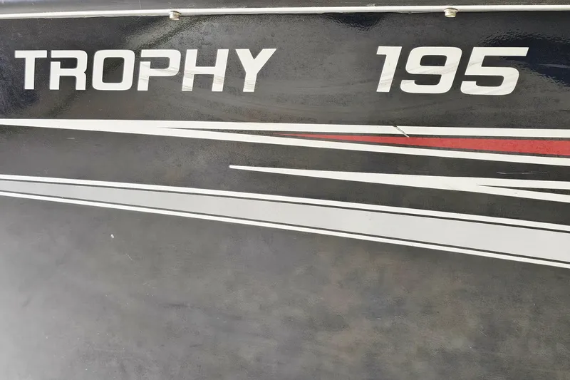 Slide: The Image of 2011 Alumacraft Trophy 195 boat decal with sleek red and white stripes. - 24