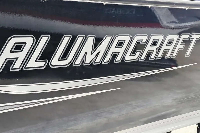 Slide: The Image of Alumacraft Trophy 195 boat, 2011 model, featuring bold logo on sleek exterior. - 25