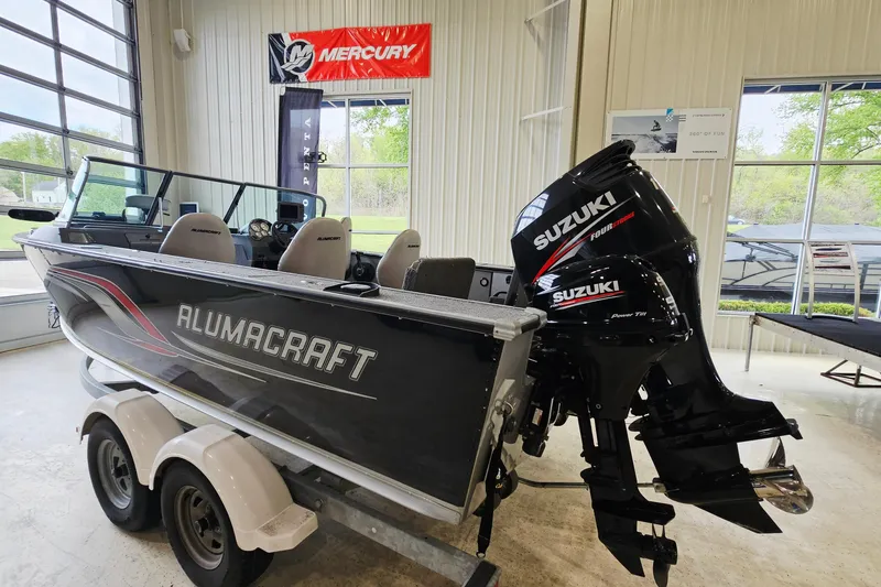 Slide: The Image of 2011 Alumacraft Trophy 195 boat with Suzuki outboard motor in showroom. - 3