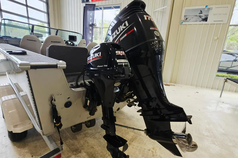 Slide: The Image of 2011 Alumacraft Trophy 195 boat with Suzuki outboard motors in a showroom. - 6