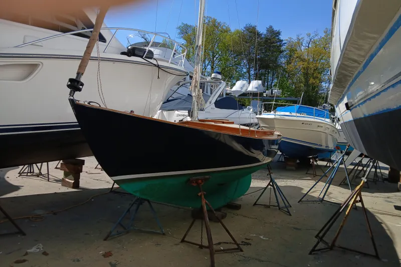 Slide: The Image of Sailboat "AlCustom Marlin 1991" in dry dock surrounded by poer boats - 3