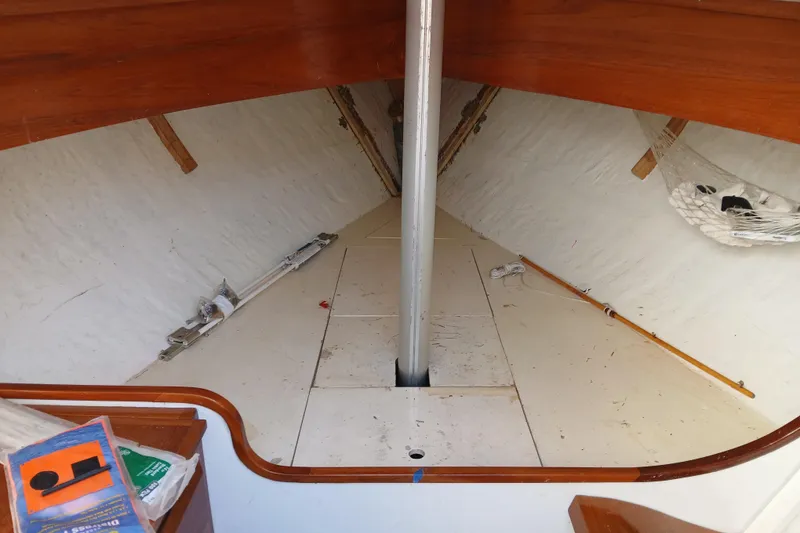 Slide: The Image of Interior of a 1991 AlCustom Marlin boat with wooden accents and storage space. - 8