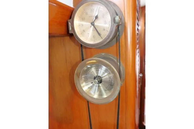 Slide: The Image of Vintage nautical instruments on 1986 Tayana 52 Center Cockpit yacht, mounted on wooden panel. - 16