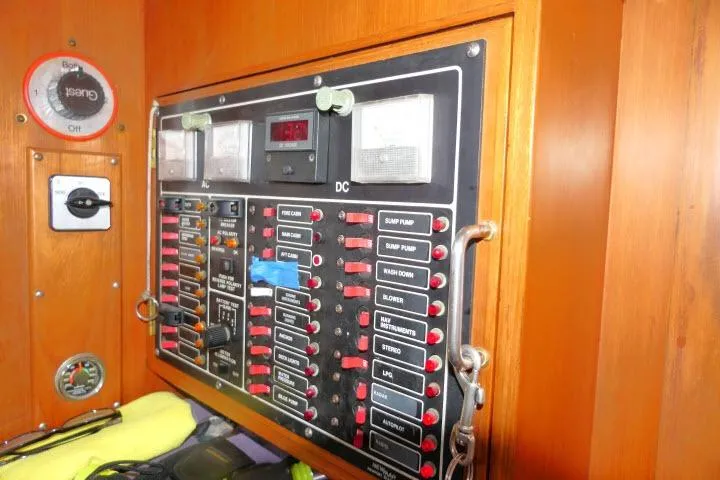 Slide: The Image of Electrical control panel on 1986 Tayana 52 Center Cockpit sailboat, featuring switches and gauges. - 17