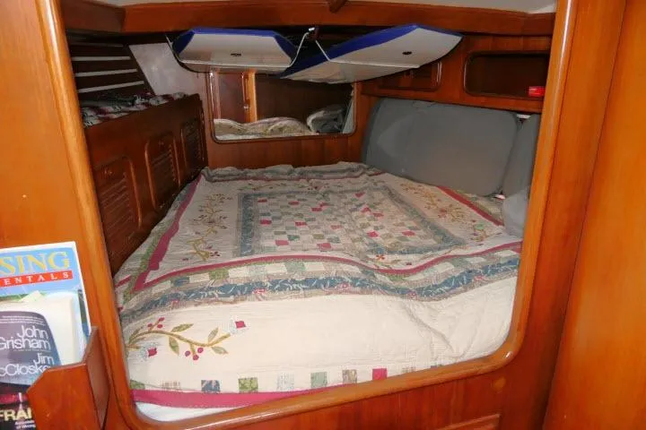 Slide: The Image of Cozy cabin interior of 1986 Tayana 52 Center Cockpit with quilted bedding. - 19