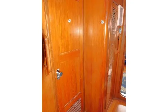 Slide: The Image of Interior view of 1986 Tayana 52 Center Cockpit, featuring wooden doors and paneling. - 21