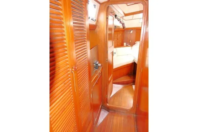 Slide: The Image of Interior of 1986 Tayana 52 Center Cockpit yacht with wooden cabinetry and cozy cabin. - 24