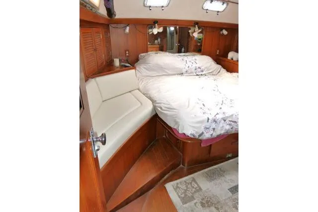 Slide: The Image of Cozy cabin interior of 1986 Tayana 52 Center Cockpit yacht with wooden furnishings. - 25