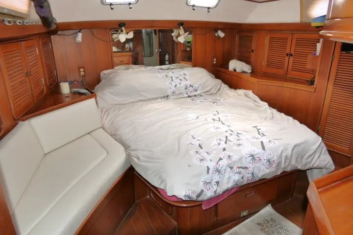 Slide: The Image of Cozy cabin interior of 1986 Tayana 52 Center Cockpit sailboat with wood paneling and bed. - 26