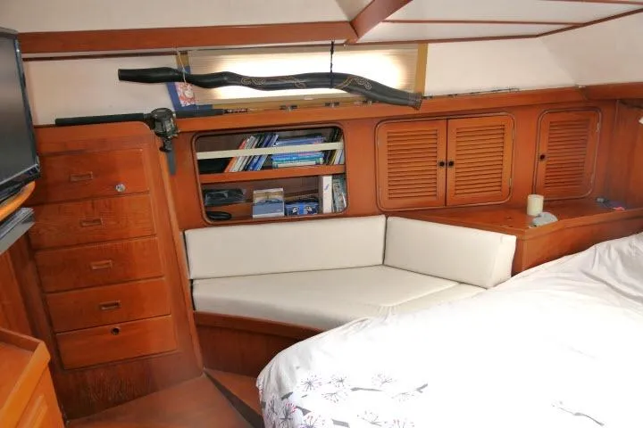 Slide: The Image of Cozy cabin interior of 1986 Tayana 52 Center Cockpit with wooden furnishings and seating area. - 27