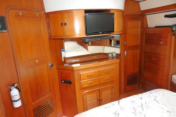 Slide: The Image of Interior of 1986 Tayana 52 Center Cockpit yacht with wooden cabinetry and mounted TV. - 29