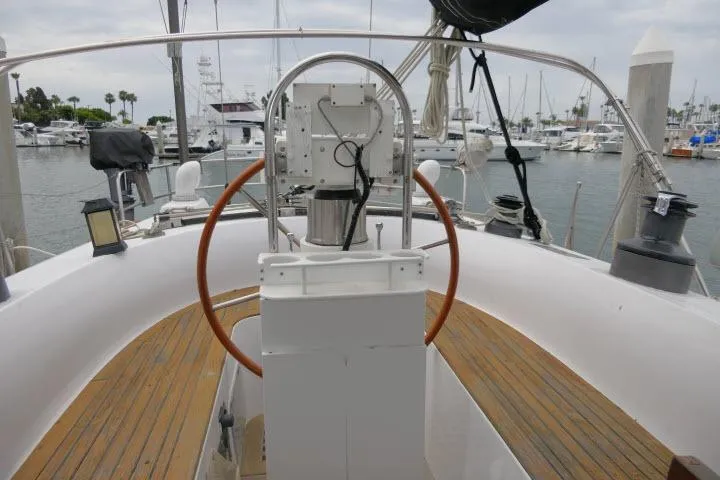 Slide: The Image of 1986 Tayana 52 Center Cockpit sailboat with wooden deck, docked at marina. - 31