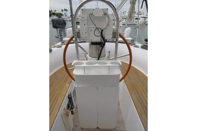 Slide: The Image of 1986 Tayana 52 Center Cockpit helm with wooden wheel and navigation equipment. - 33