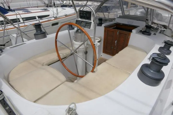 Slide: The Image of Cockpit of 1986 Tayana 52 Center Cockpit sailboat with wooden wheel and seating. - 35