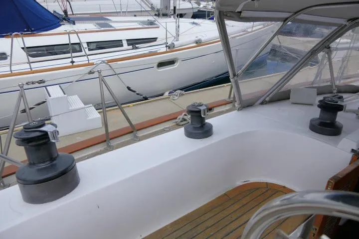 Slide: The Image of 1986 Tayana 52 Center Cockpit sailboat with winches and teak deck, docked beside another yacht. - 42