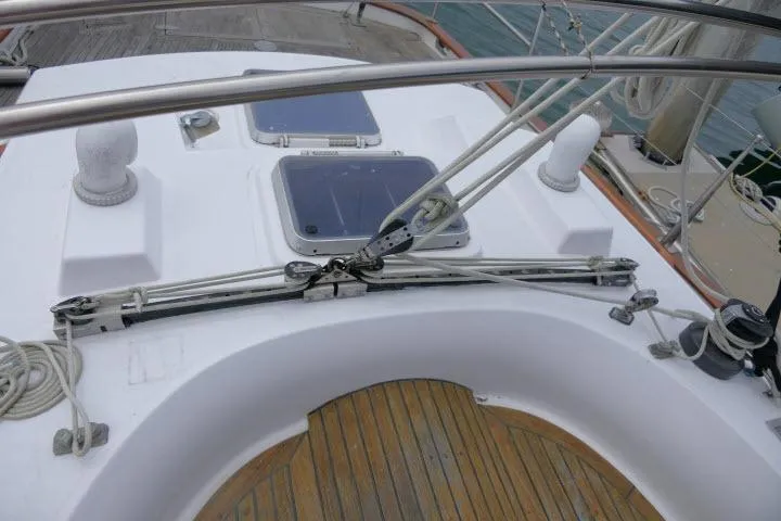Slide: The Image of 1986 Tayana 52 Center Cockpit sailboat deck with rigging and teak flooring. - 45