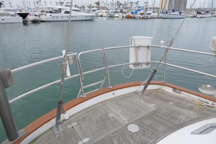 Slide: The Image of Deck view of 1986 Tayana 52 Center Cockpit yacht in a marina setting. - 49