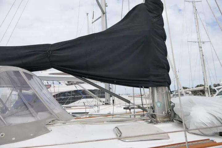 Slide: The Image of Sailboat Tayana 52 Center Cockpit, 1986 model, with covered mainsail at marina. - 55